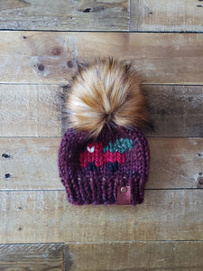 Lemon Tree Lane Baby 0-3 Months "Little Red Truck" Beanie | Rust Tones with Design on Front of the Iconic Red Truck carrying a Christmas Tree/Caramel Faux-Fur Pom Pom